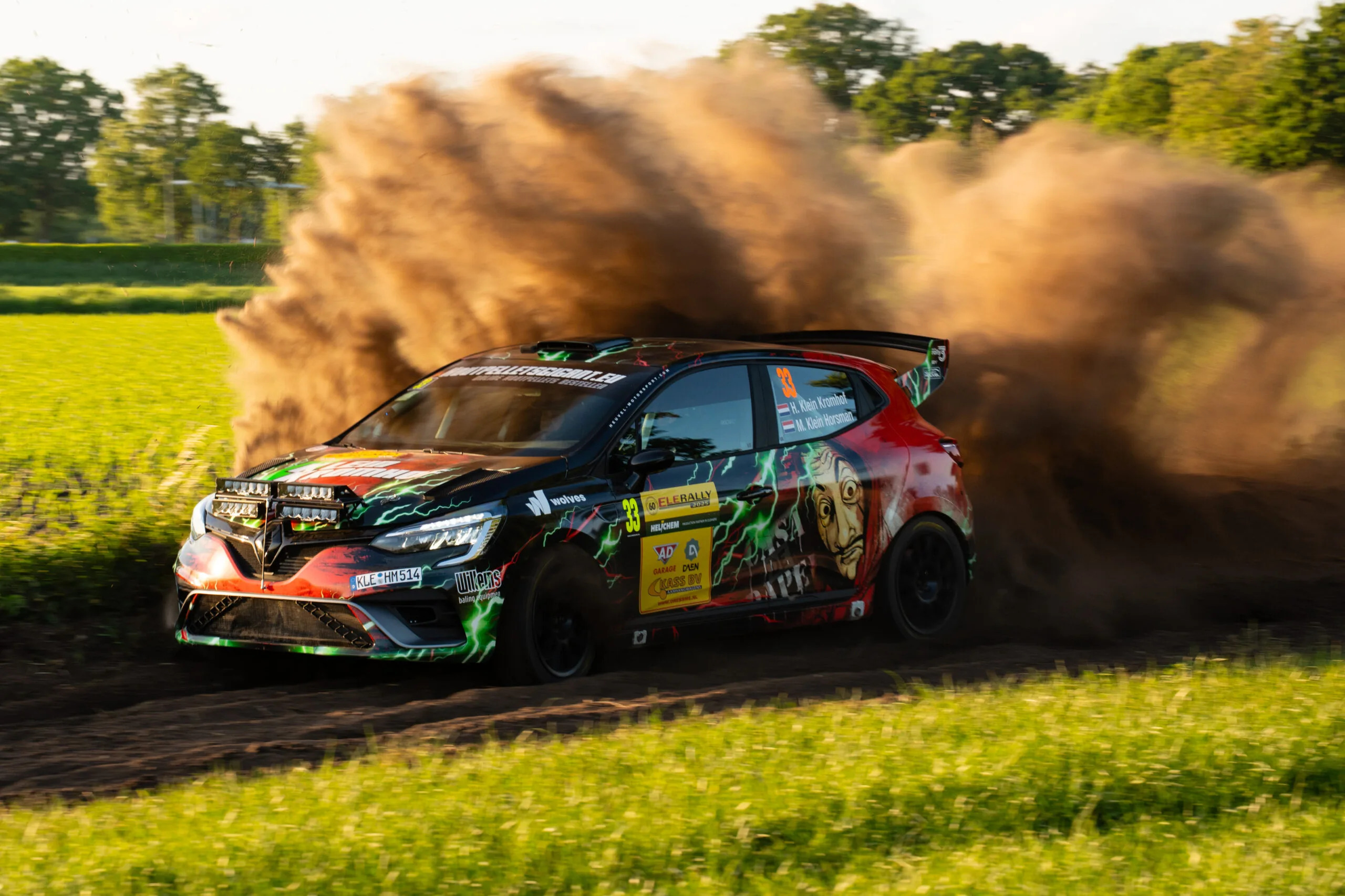 Rally car throwing up a cloud of dust on a gravel stage
