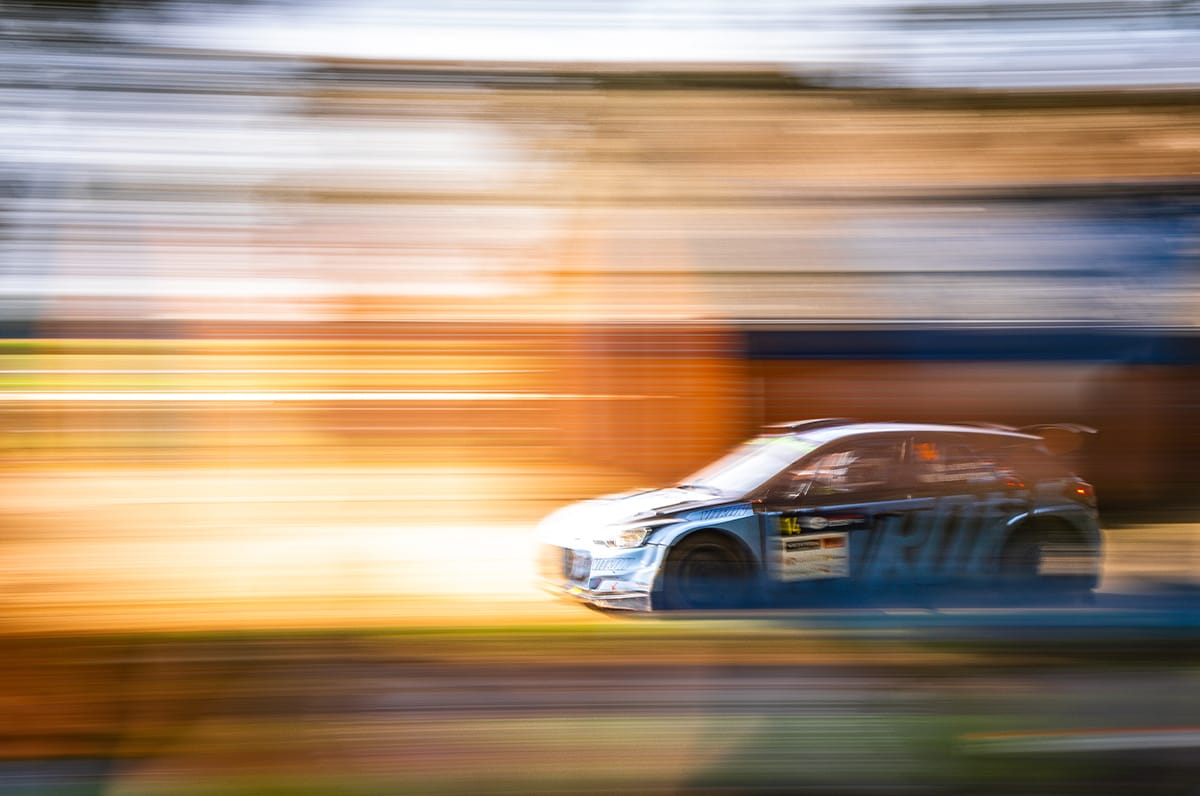 Rally car frozen sharp with a panning technique against a streaked background