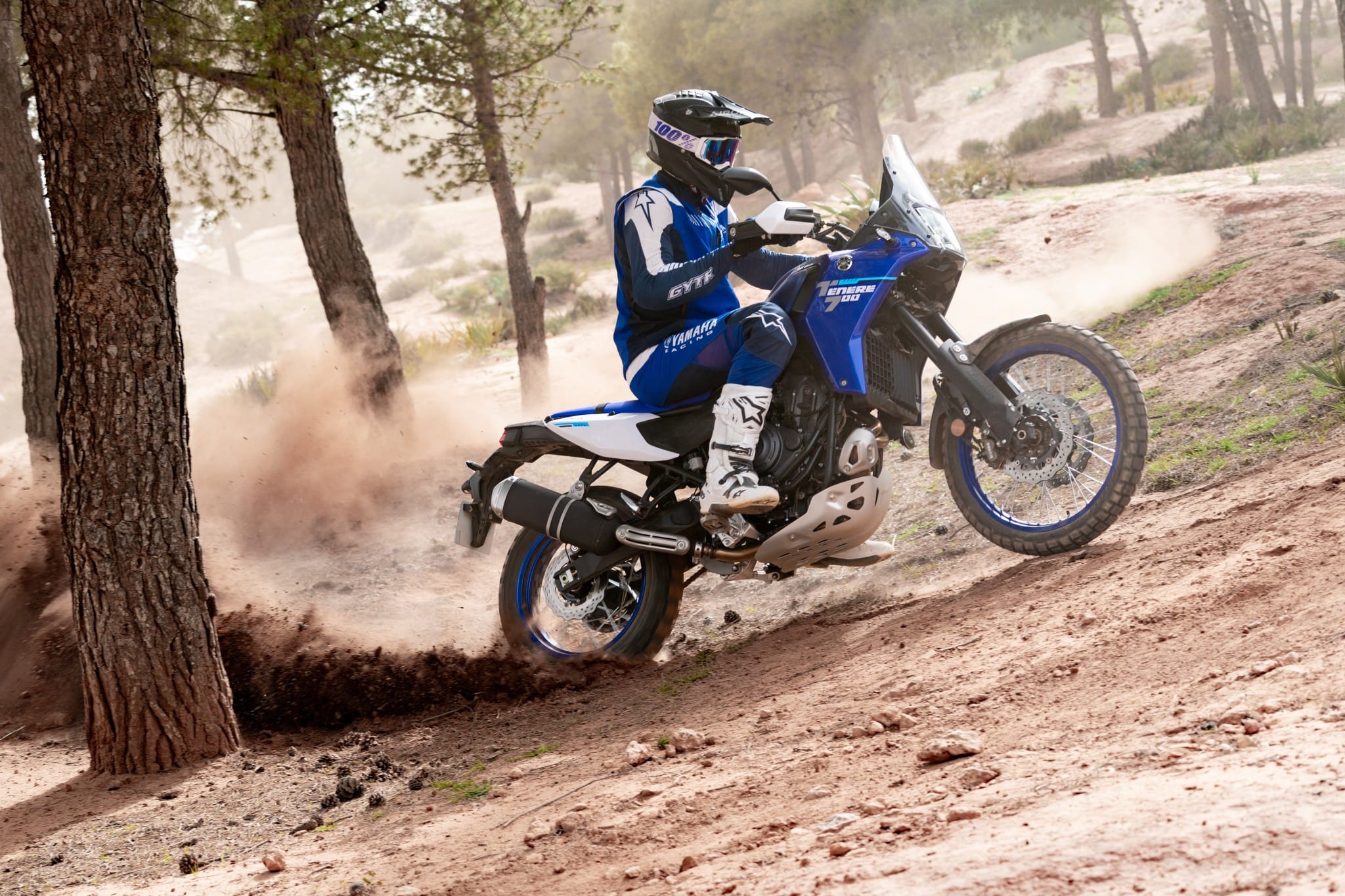 Yamaha Ténéré 700 kicking up sand between the trees