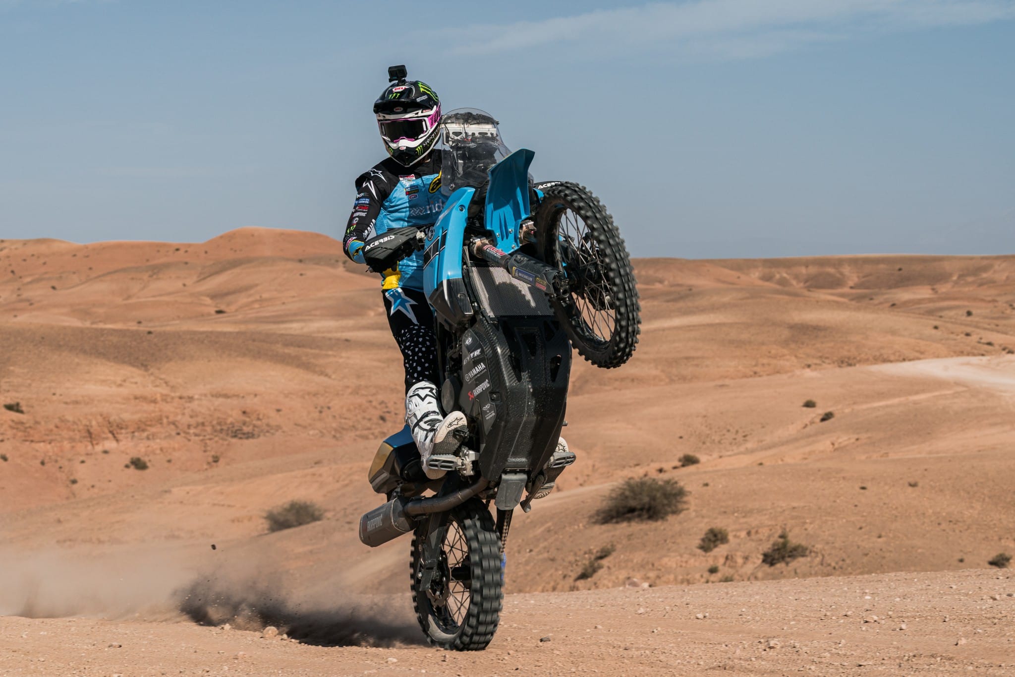 Rally rider pulling a wheelie on the Ténéré in the Agafay desert