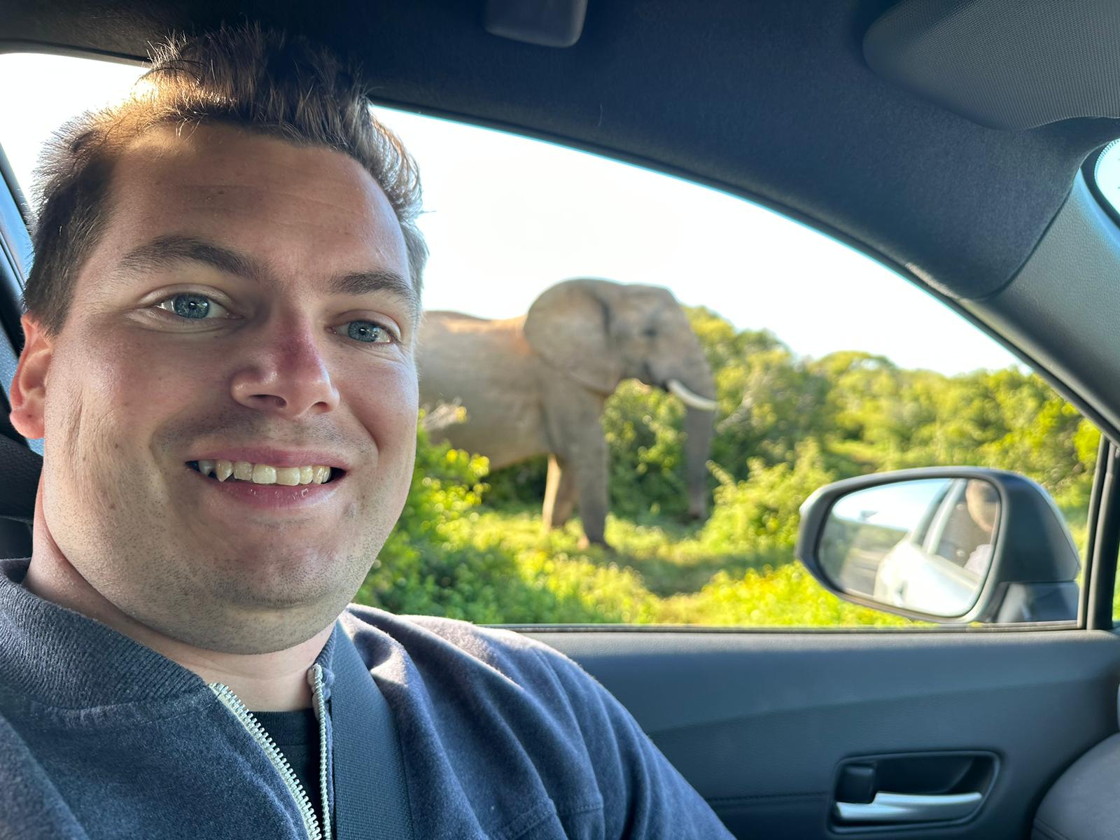 Robin Verheggen in the safari vehicle with an elephant just off the track